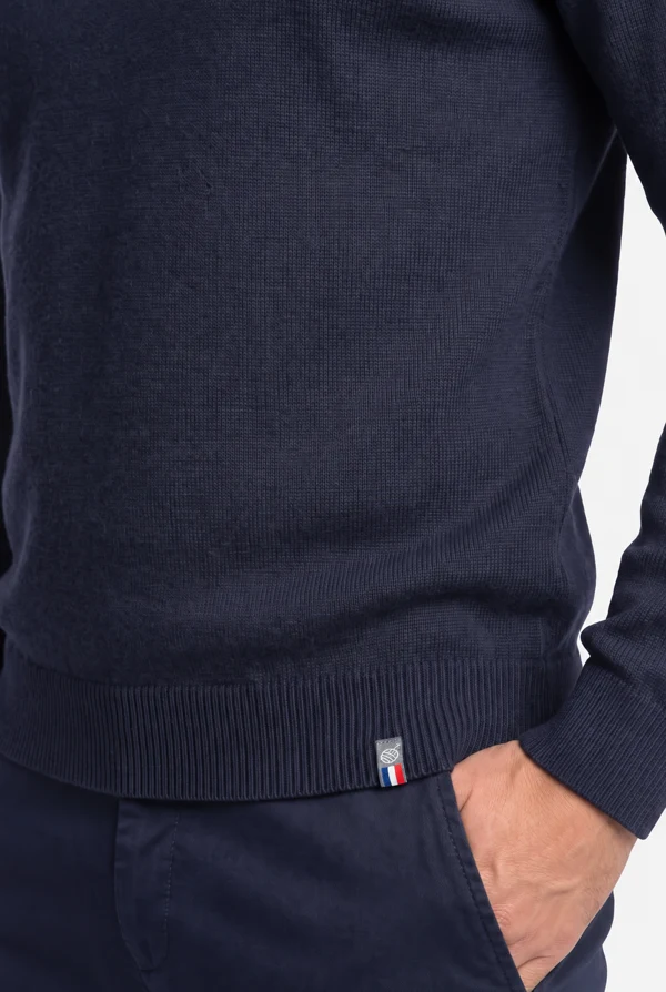 Ribbed hem of the PELOT made-to-measure sweater with the crest and French flag, hand in pocket.